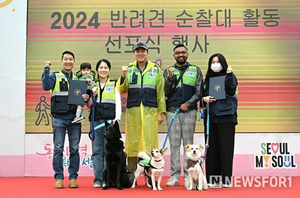 오세훈 서울시장이 20일(토) 월드컵공원 평화의광장에서 열린 2024 서울 반려견 순찰대 활동 선포식에 참석해 대표 순찰대원들에게 위촉장을 수여하고 순찰대 패치를 부착해준 후 기념촬영을 하고 있다.